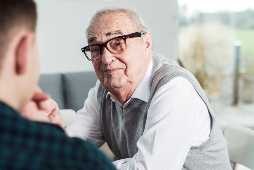 Old man looking at young man